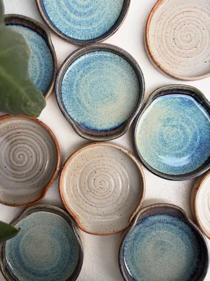 Our spoon rests are always in high demand. This overhead shot shows the beautiful variety of our studio-mixed glazes, including the drippy rutile and earthy shino finishes. Each one is a small piece of functional art for your kitchen.