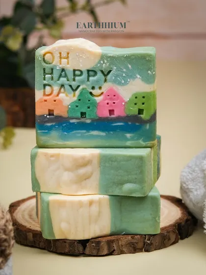 A closer look at the "Oh Happy Day" soap, stacked to show the smooth, creamy texture of the cold-pressed bars. Each one is a solid, long-lasting piece of art for your bathroom.