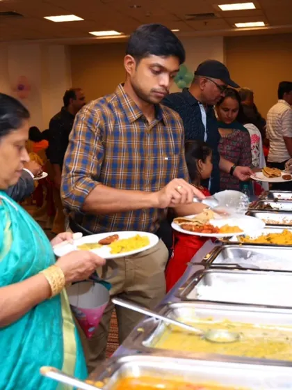 Guests choosing from a wide array of dishes at our buffet station, including rice, curries, and breads.