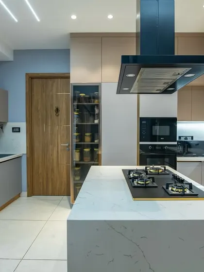 I believe a kitchen should be the functional heart of the home. This design features a clean, open layout with a central island, perfect for cooking and conversation. The soft blue-gray cabinets and handleless design create a tranquil, minimalist look that is both timeless and easy to maintain.