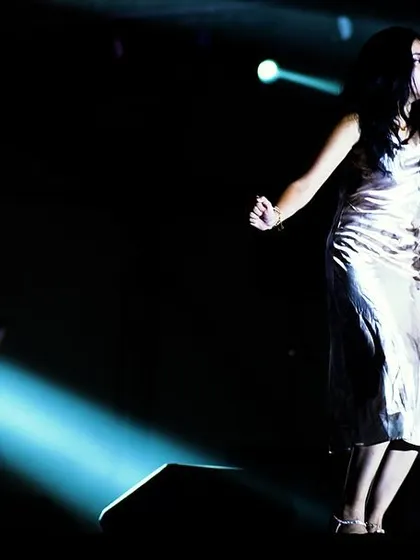 A dramatic solo moment on stage, captured with a single spotlight. These moments allow for a deeper connection with the music.