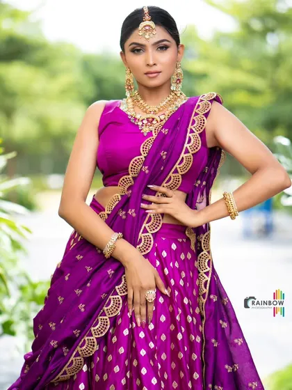 A full-length view of the purple half saree, demonstrating its regal silhouette and rich, traditional appeal.