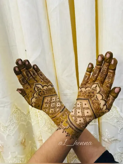 A stylish crossed-hands pose showing a beautiful geometric and floral design.