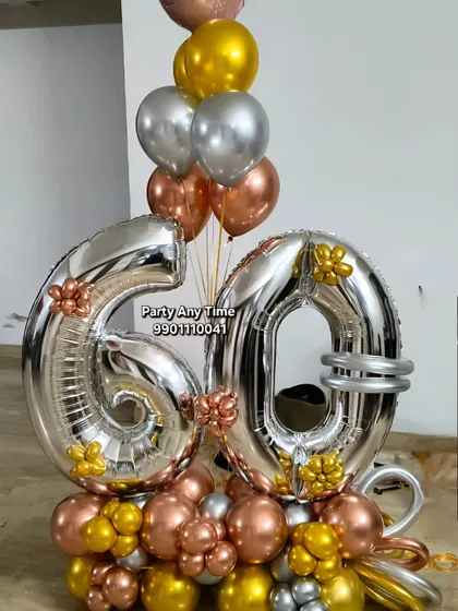 I design custom balloon bouquets for any milestone. This one for a 60th birthday uses large silver foil numbers, surrounded by a mix of rose gold, silver, and gold chrome balloons. These are great as a centerpiece or a surprise gift.