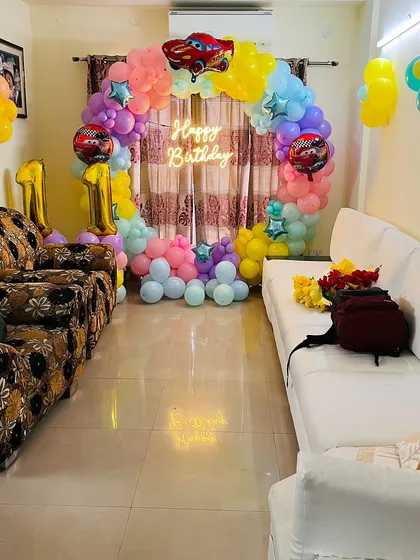 A wide shot of the "Cars" theme decoration in a living room, showing how our setups can transform any space into a party zone.