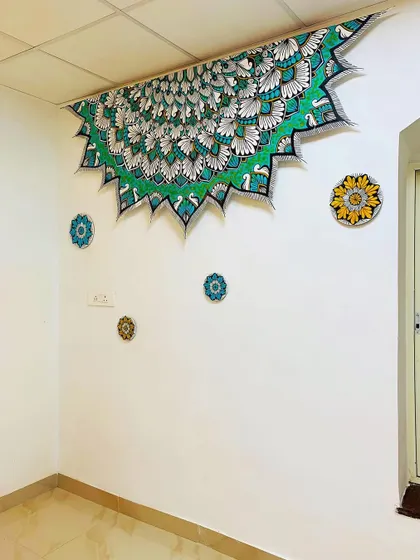 A custom peacock themed mandala designed to be installed on the ceiling. The unique shape and vibrant green and white colors make it a stunning and unexpected feature.