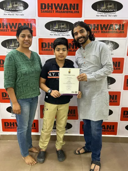 A proud family moment celebrating a student's Trinity College London certification. We share in the joy of every milestone our students achieve.