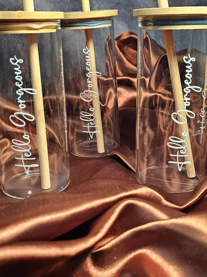 A new addition to my collection: elegant glass tumblers with a bamboo lid and straw. I can customize them with a name or a phrase like 'Hello Gorgeous' for a chic and eco-friendly gift.