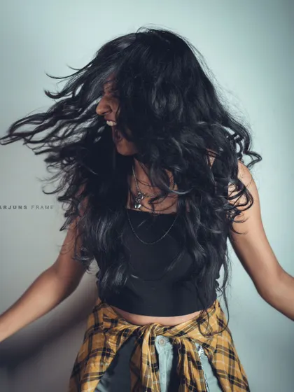 A high-energy shot with a hair flip that captures pure, raw emotion. This is the kind of authentic movement I bring to photoshoots to make them feel alive.
