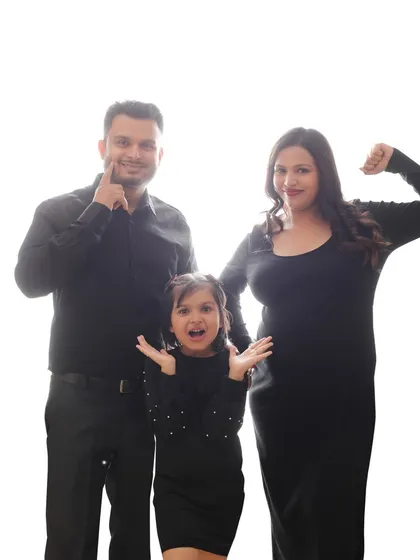 A fun and playful family portrait before they become a family of four. This shot captures the excitement and personality of the parents and their daughter.