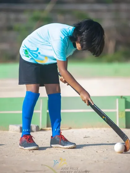 A young girl from our 2022 camp, poised and ready with her hockey stick.