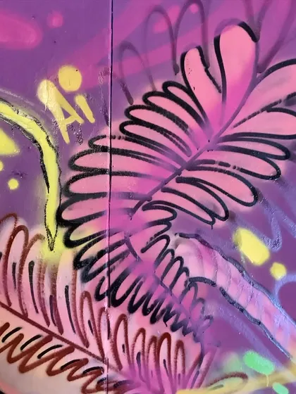 Detail of the pink and purple fern-like shapes from the floral piece.