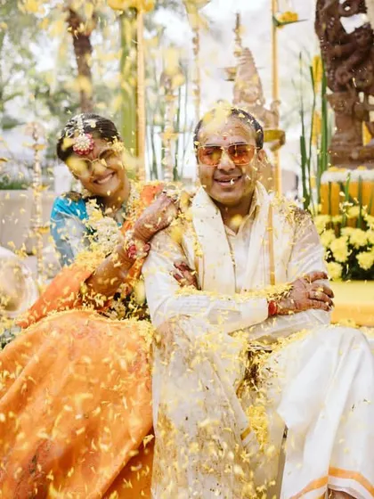 A playful flower shower for the couple during their Haldi. These moments of spontaneous joy are what make a wedding unforgettable.