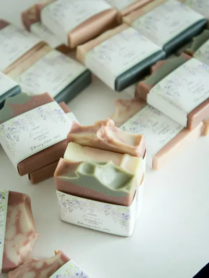 A small stack of the assorted soaps included in the lavender and sage-themed baby shower favors.