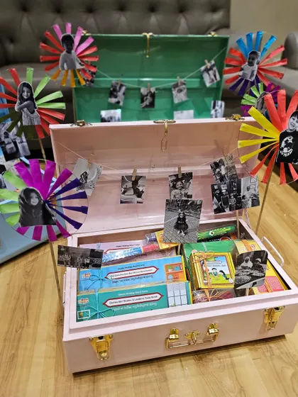 A closer look at the nostalgic kids' trunks. The combination of pastel colors, personal photos clipped to a string, and handmade pinwheels really uplifts the whole look.