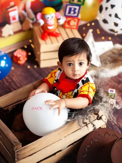 Sitting in a rustic crate, our little cowboy looks right at home in the Toy Story universe. The backdrop and props bring the movie to life.