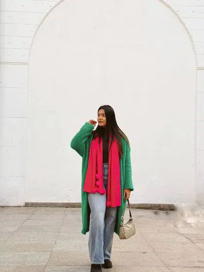 Another cozy winter look, this time pairing a bright green teddy coat with a hot pink scarf and casual jeans.