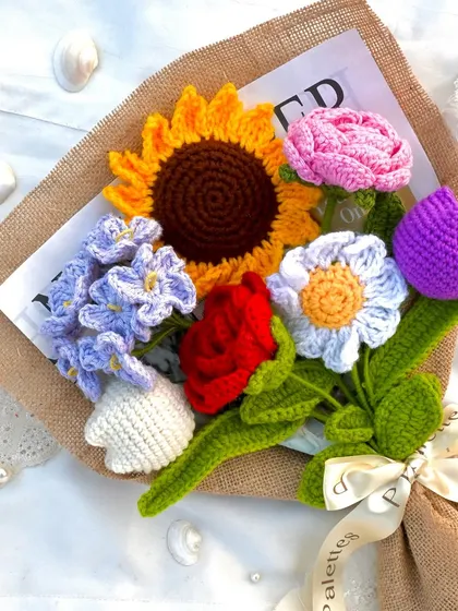 A vibrant and cheerful mix of my favorite crochet flowers. This "Ensemble" bouquet includes a sunflower, rose, tulip, daisy, and more, all wrapped in rustic jute paper.