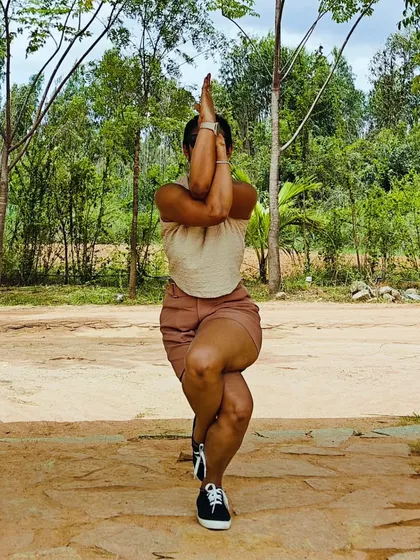 Eagle Pose, or Garudasana, in a natural setting. This balancing pose strengthens my legs and opens my shoulders while helping me cultivate focus and stability.