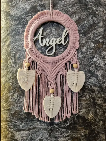We love making things personal. This custom macrame name hanging with the name 'Angel' is a beautiful example of how we can add a unique touch to a nursery, a kid's room, or as a thoughtful gift.