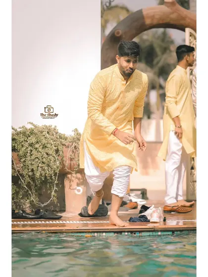 Getting ready for some poolside fun! A candid shot of a guest at a Haldi pool party.