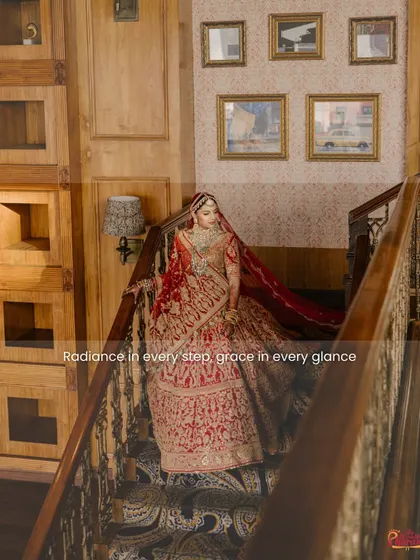 Radiance in every step, grace in every glance. The bride descends a grand staircase, her lehenga flowing, a moment of pure cinematic beauty.
