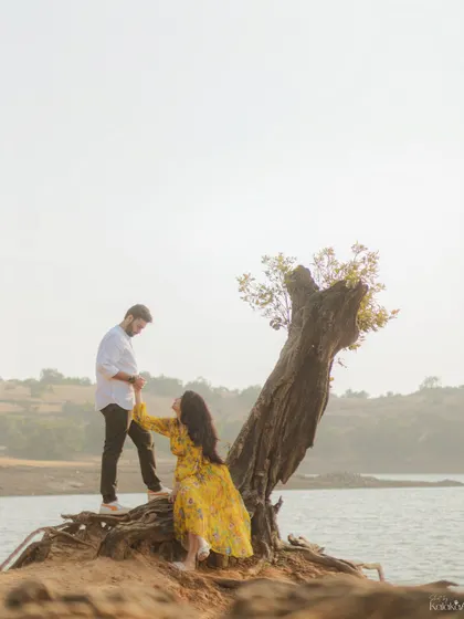 An adventurous and romantic shot by the lakeside, with the couple framed by a uniquely shaped tree. We love finding creative compositions in nature.