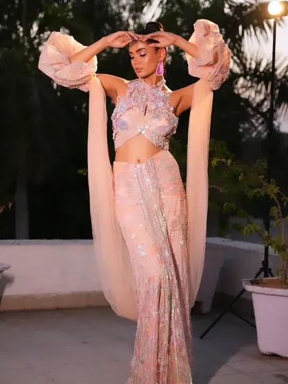 A powerful, editorial pose that showcases the full drama of the sleeves.