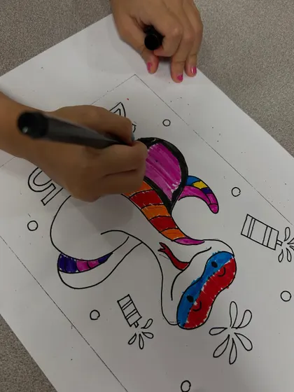 Another student gets creative with a rainbow-coloured snake. I love seeing their unique colour choices.
