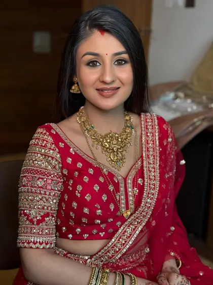 A close-up portrait highlighting the beautiful reception makeup. The skin is glowing, the eyes are softly smoked, and the lip color is a perfect nude.