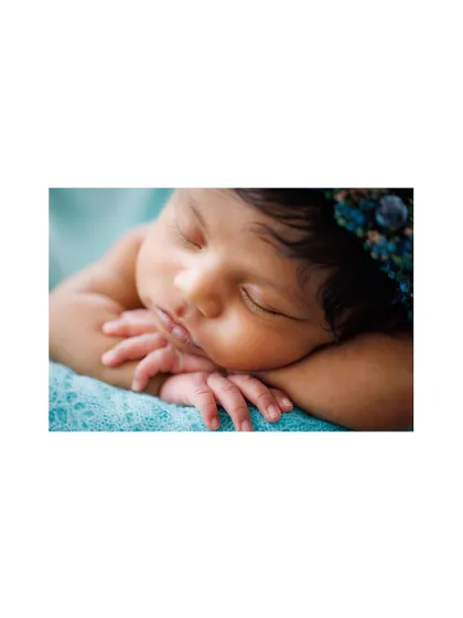 This macro shot focuses on the serene expression and tiny, clasped hands of a sleeping newborn. Preserving these minute details is my passion, creating memories you will treasure forever.