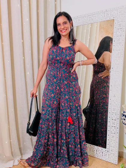 A tiered floral jumpsuit in a beautiful shade of teal. The tassel detail adds a fun, bohemian touch.