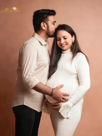A tender kiss on the forehead is a simple gesture filled with so much love. This is a beautiful moment from a classic couple's maternity shoot.