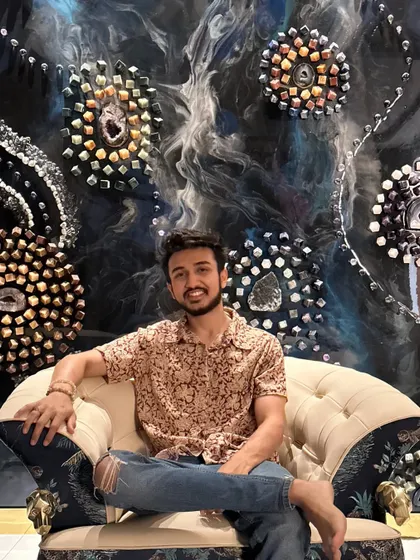 Here I am, sitting in front of the massive astrology-themed conceptual wall art. It was a huge project that I'm incredibly proud of, created with a talented team.