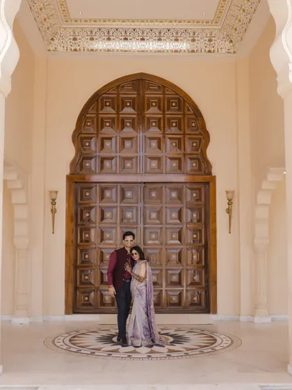 A classic couple portrait in front of the grand entrance at Anantara Jaipur.