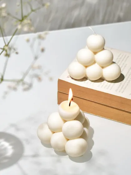 Another shot of our pyramid bubble candle, both lit and unlit. It's a true piece of art.