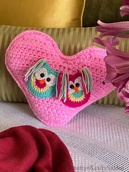 A close-up of the Valentine's owl heart cushion, showing the cute, colourful owls nestled together.