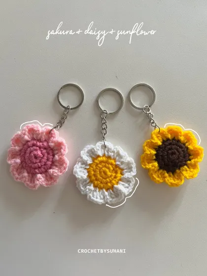 A vibrant set of my most popular flower keychains: a pink sakura, a classic white and yellow daisy, and a sunny sunflower. These add a pop of color to anything.