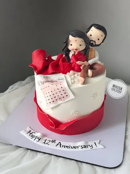 A sweet 12th-anniversary cake featuring a custom figurine of the couple and an edible calendar marking their special day. It’s a beautiful way to celebrate a milestone.