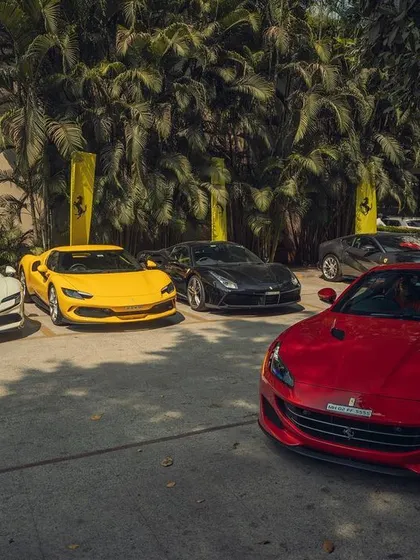 A vibrant collection of Ferraris, including the 296 GTB and Portofino, at the weekender event. My goal is to match the energy of these incredible machines with my music.