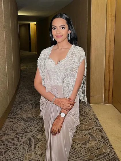 A full view of this elegant and edgy look. The pearlescent skin and glossy lips create a beautiful contrast, making for a memorable party look.
