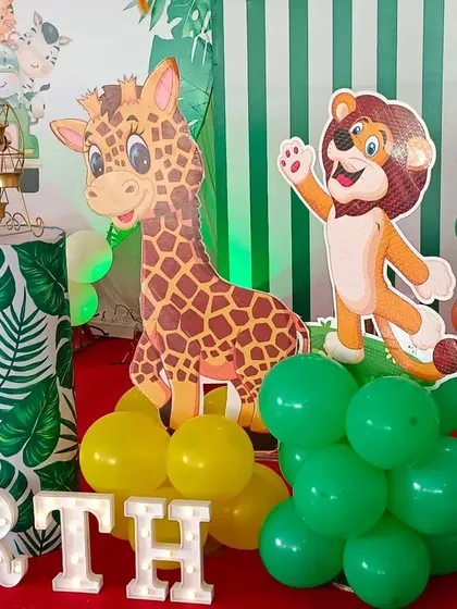 More details from our jungle theme party. We use character cutouts like giraffes and lions, along with marquee letters for the name, to make the setup extra special.
