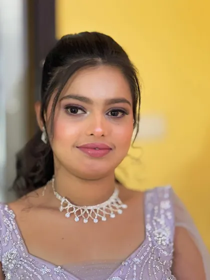 A simple and elegant party look. The makeup is natural and fresh, enhancing her features without being too heavy.