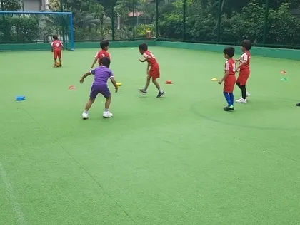 A player in purple stands out, showing that every child's individuality is celebrated in our team environment.