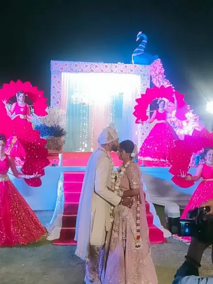 A duplicate image of the beautiful Varmala ceremony, framed by our dancers and their peacock-themed props.