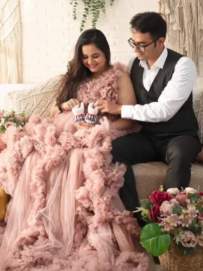 It's all in the details. We used tiny "I love Mom" and "I love Dad" baby shoes to add a personal and adorable touch to this couple's portrait.