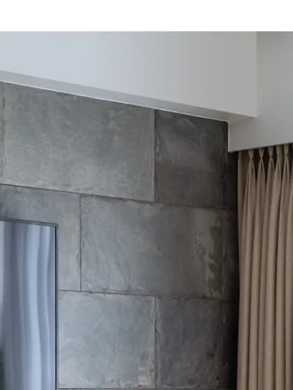 A close-up of the corner of the slate tile wall, showing the precision of the installation and the beautiful, rugged texture of the natural stone.