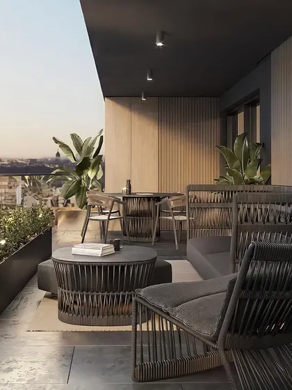 Another perspective of the tropical-themed balcony, showing the dining and lounging areas. The design provides ample space for both relaxation and entertaining while connecting with the urban environment.