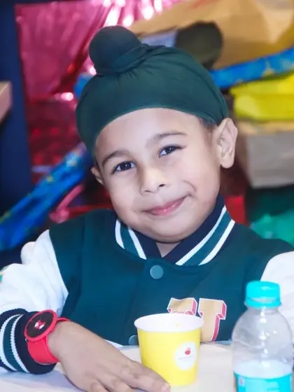A close-up portrait of a young boy smiling at his birthday party. We capture the happy and relaxed expressions of children enjoying their special day.