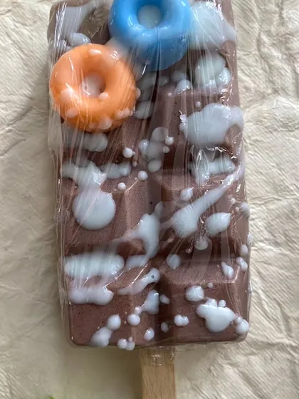 A close-up of a chocolate-themed popsicle soap. The little donuts on top are also soap, adding an extra layer of fun.